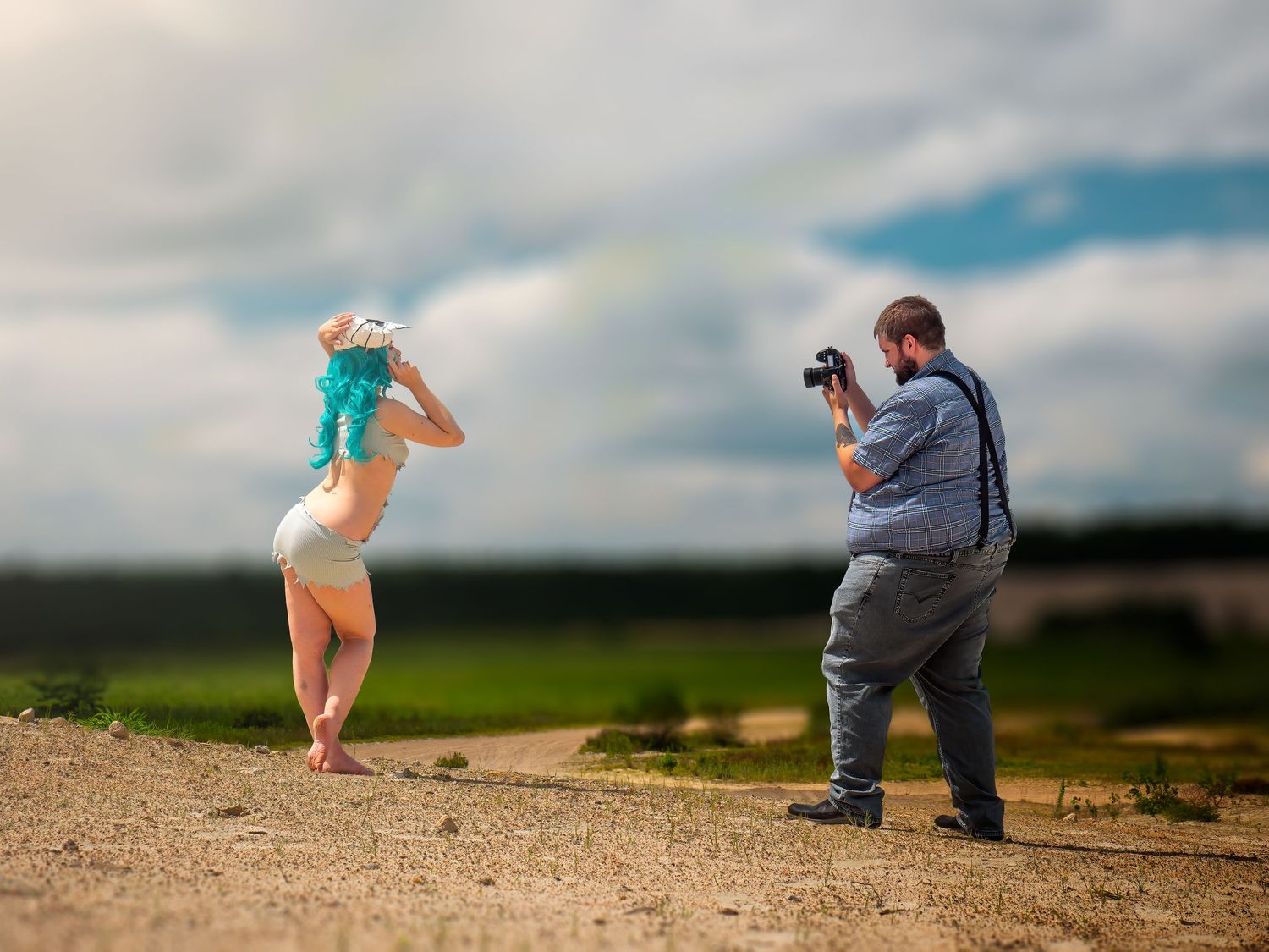 A photographer captures a costumed performer posing dramatically on a hilltop against cloudy skies.
