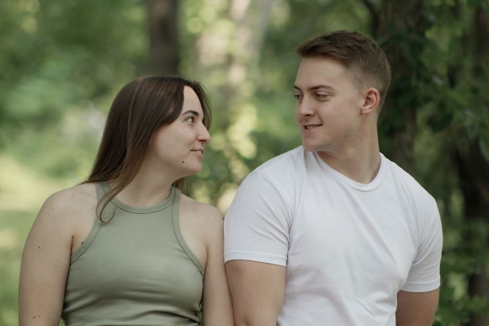 Intimate couple's portrait session with natural woodland backdrop.