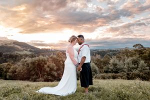 Golden hour wedding photos on the top of a hill by Matua Riverside Retreat.