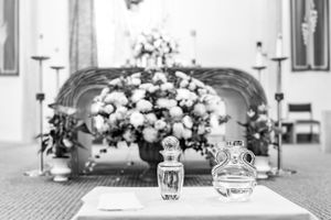Black and white wedding ceremony setup with elegant flower arrangement and decorative details.