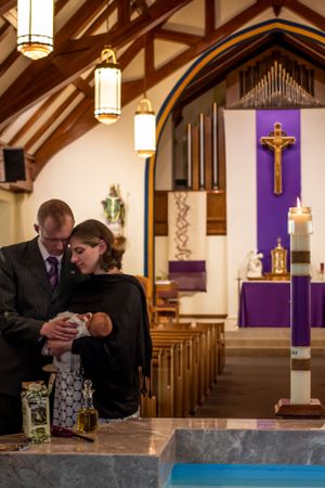 Church interior with purple Lenten decorations and baptismal font.