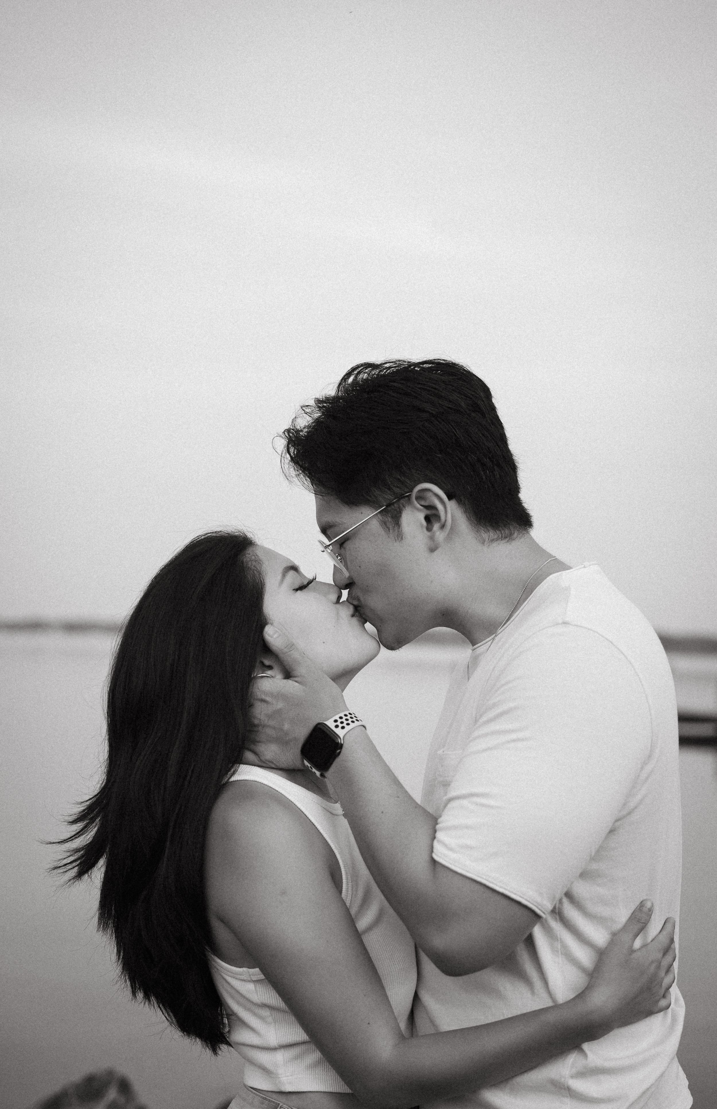 couple kissing by lake