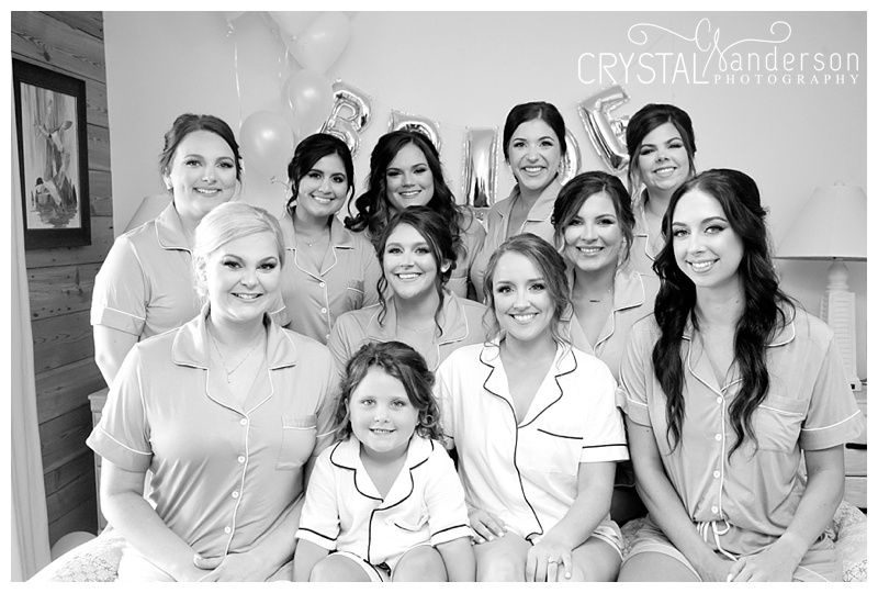Group of bridesmaids in white robes getting ready for a wedding celebration.