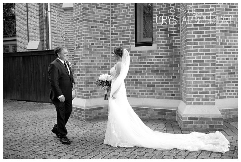 Black and white wedding photos against brick wall backdrop.