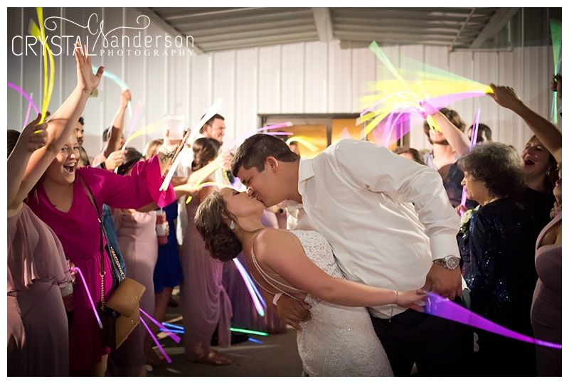 Colorful glow sticks light up the dance floor as wedding guests celebrate together.