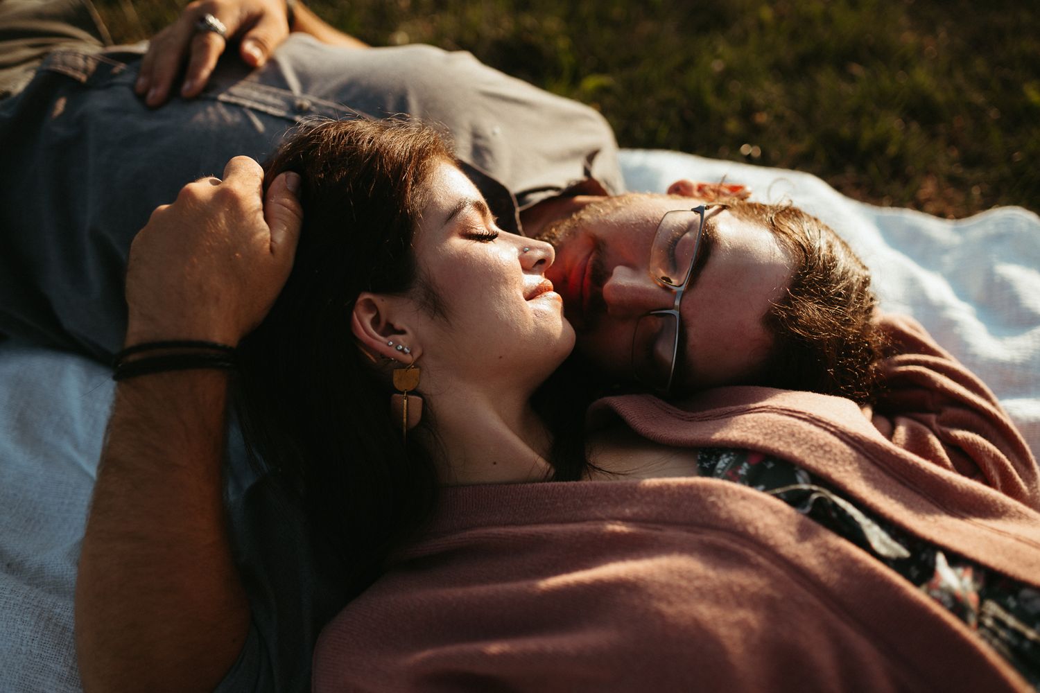 Close up of a couple laying down on a blanket during their engagement session at Meadowbrook park in Urbana, Illinois
