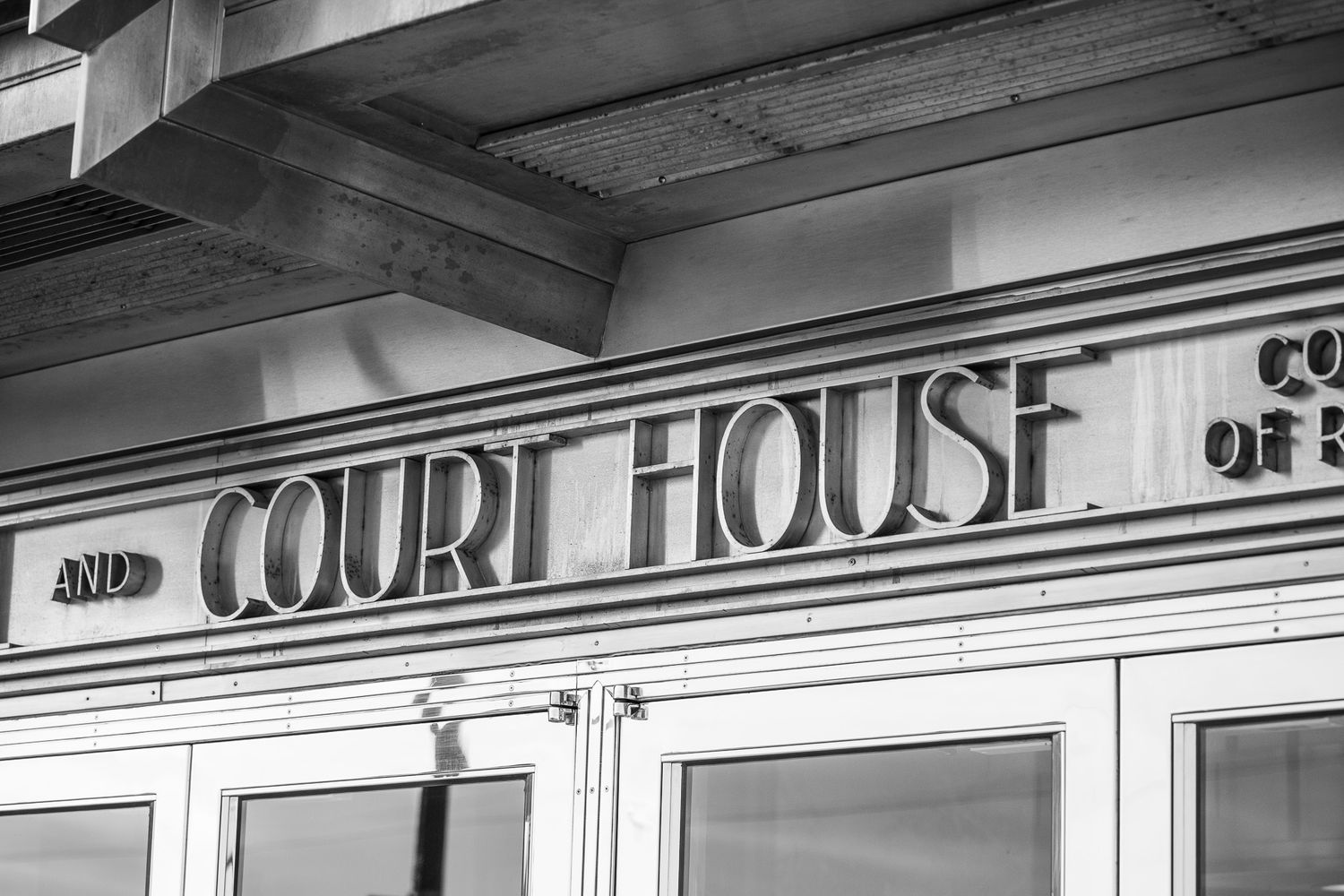Vintage courthouse sign in black and white with art deco styling.