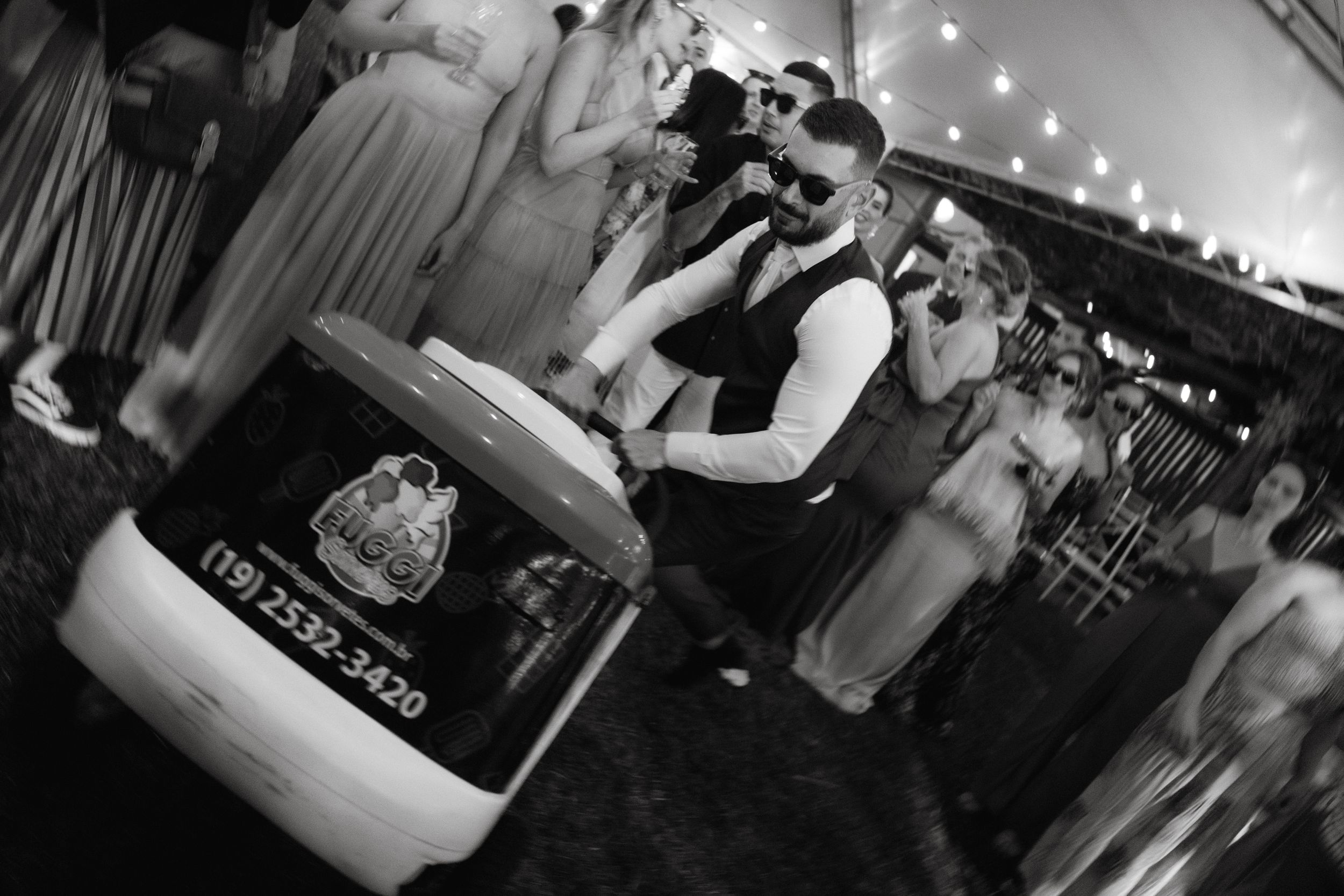 Black and white shot of wedding reception bar service with dramatic lighting.
