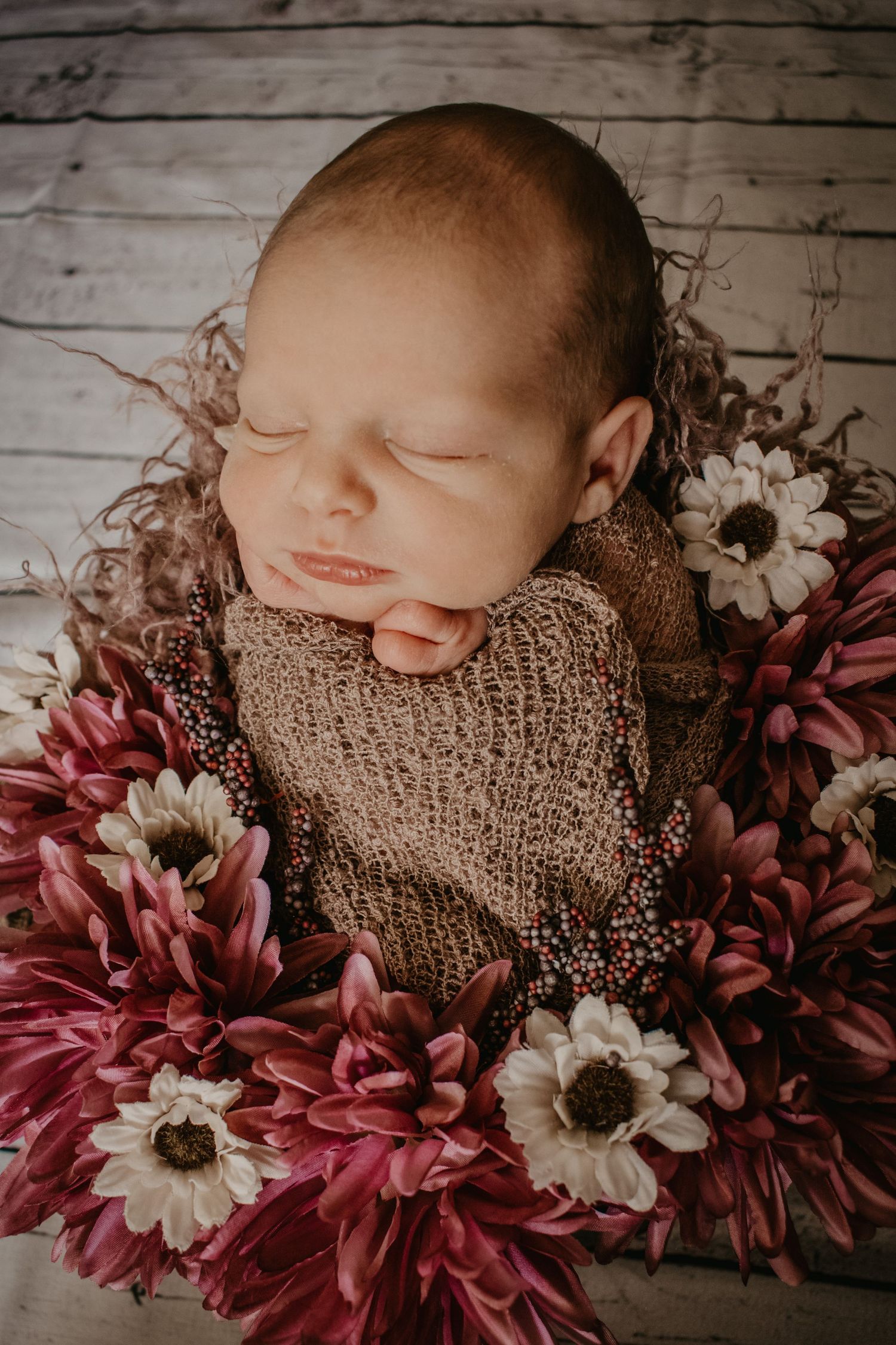 Newborn baby sleeping in flowers