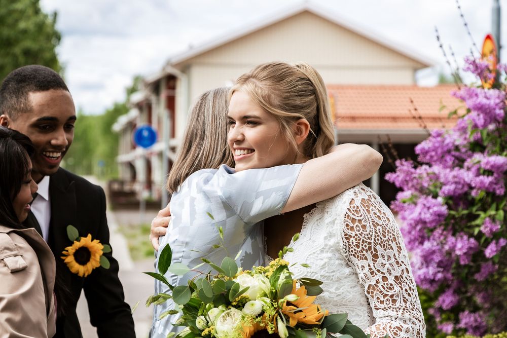 Wedding celebration with sunflower bouquet and purple flowering bushes.