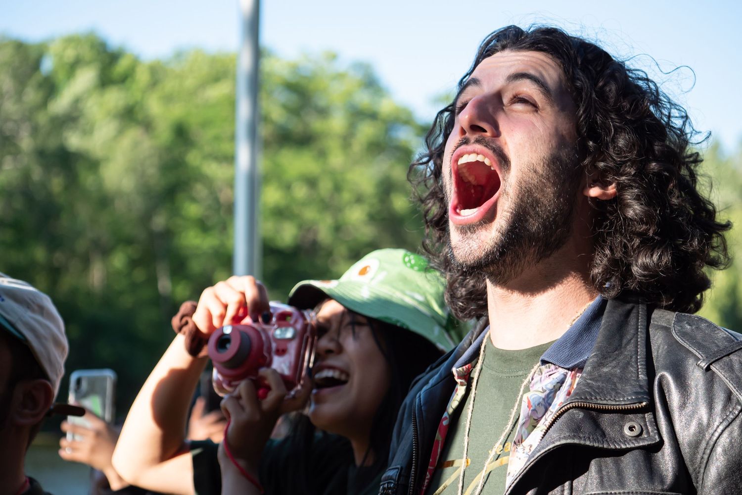 Outdoor non-profit staff smiling with excitement.