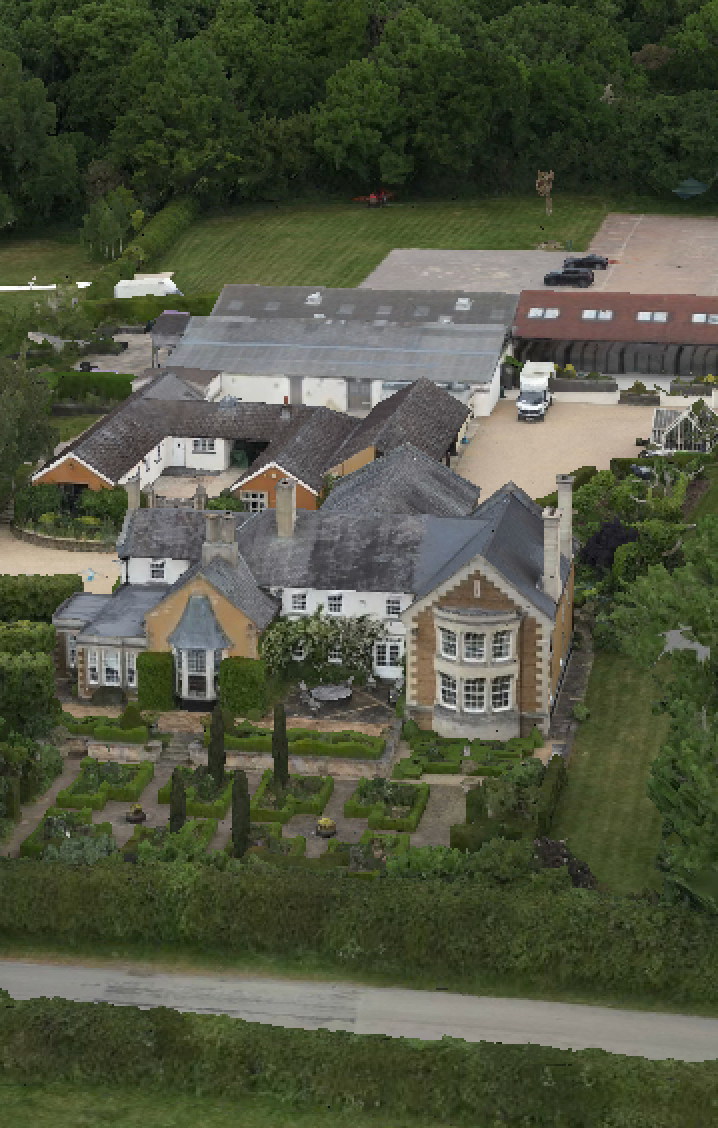 Aerial photograph of a large residential complex with multiple wings and landscaped gardens.