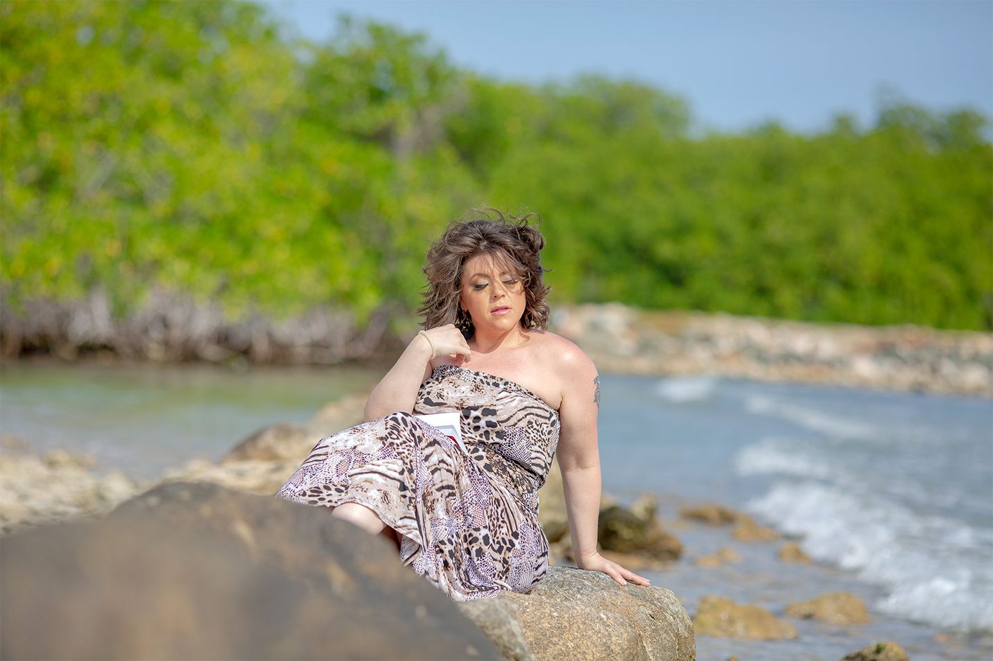 Female posing on rocks on Beach
