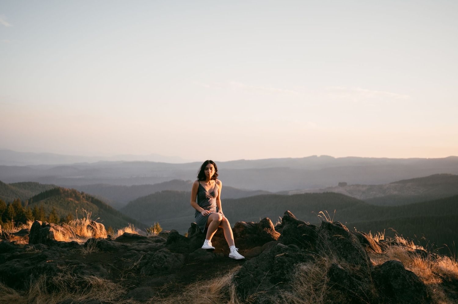 Panoramic view of mountain ranges stretching into the distance under a dusky sky.