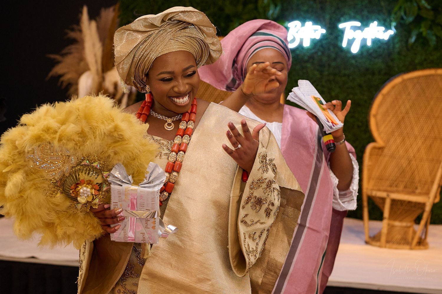 Guests in traditional Nigerian attire celebrate with yellow decor elements at an event.