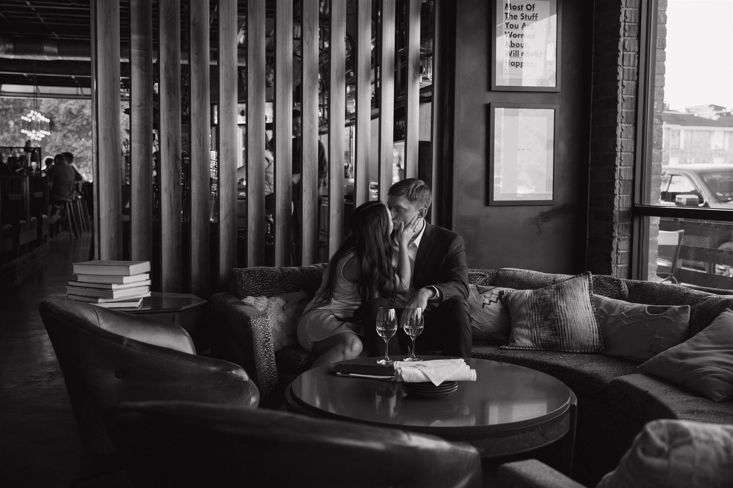 Black and white photo of couple in modern restaurant lounge setting.