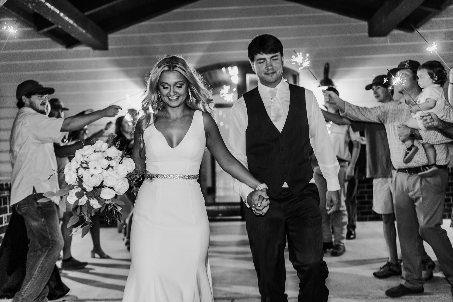 Black and white wedding reception celebration with dancing guests.