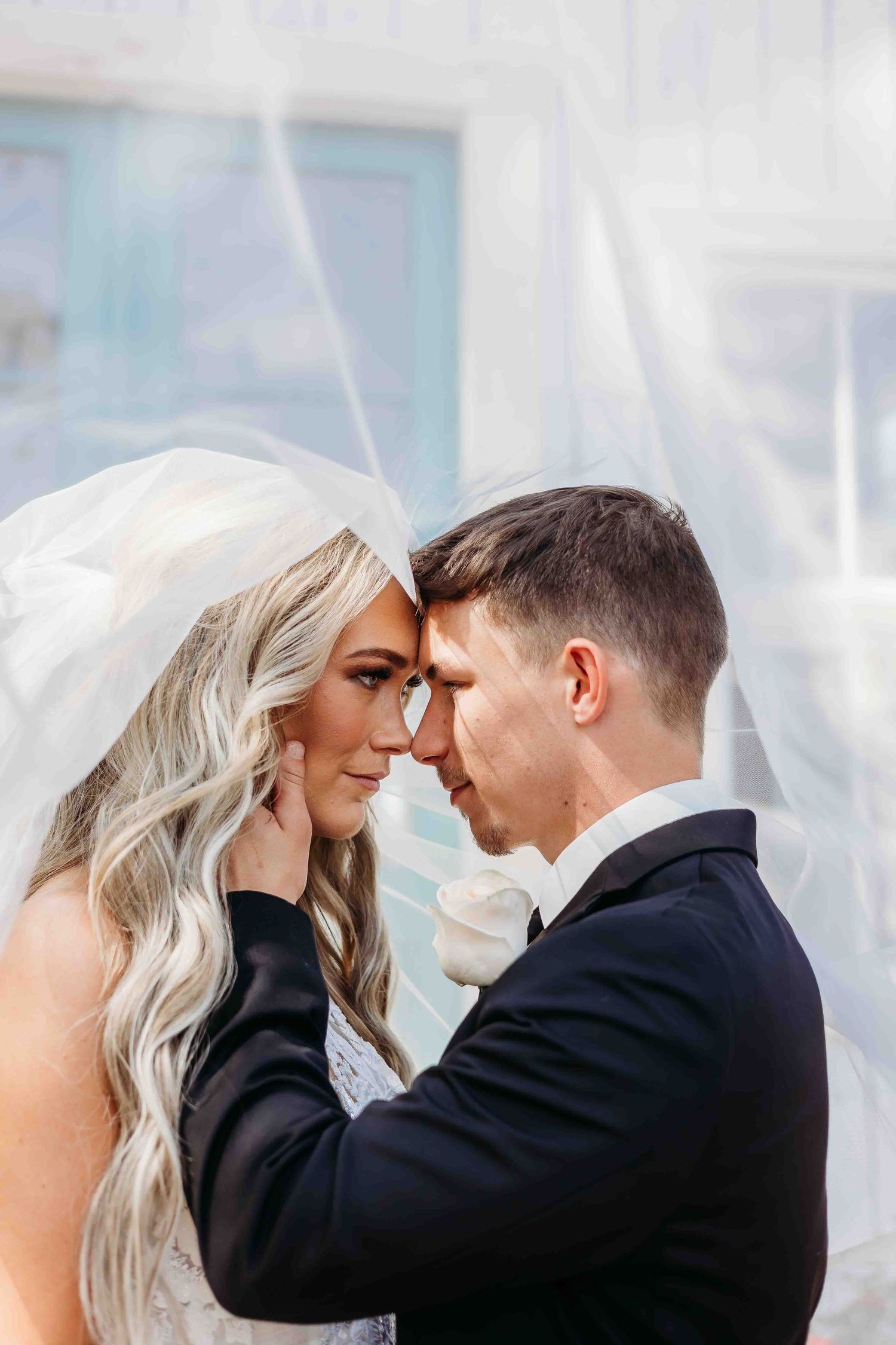 Tender wedding moment captured in a series of close-up portraits with soft lighting.