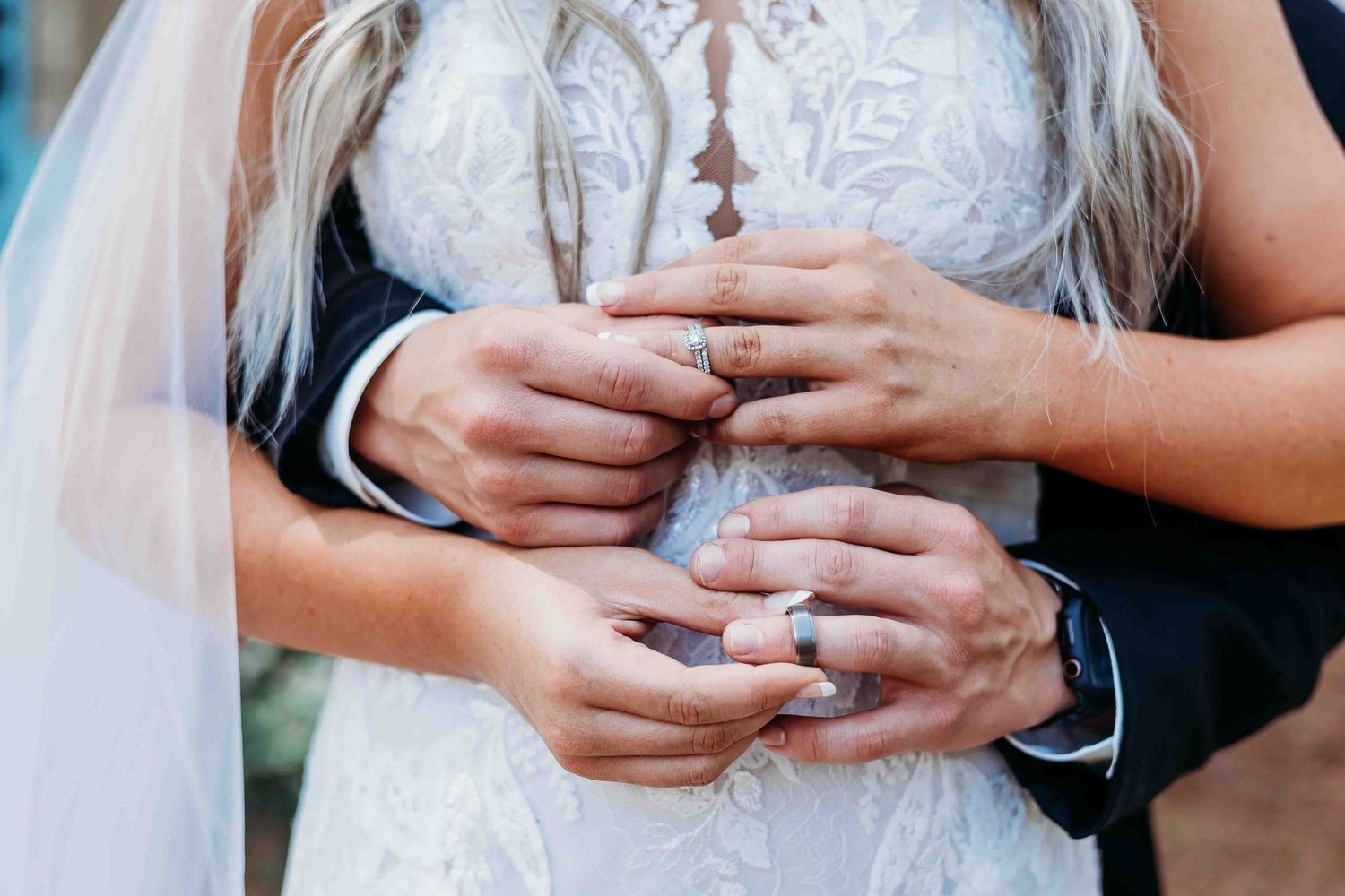 Series of close-up photos focusing on hands and wedding rings against lace dress details.