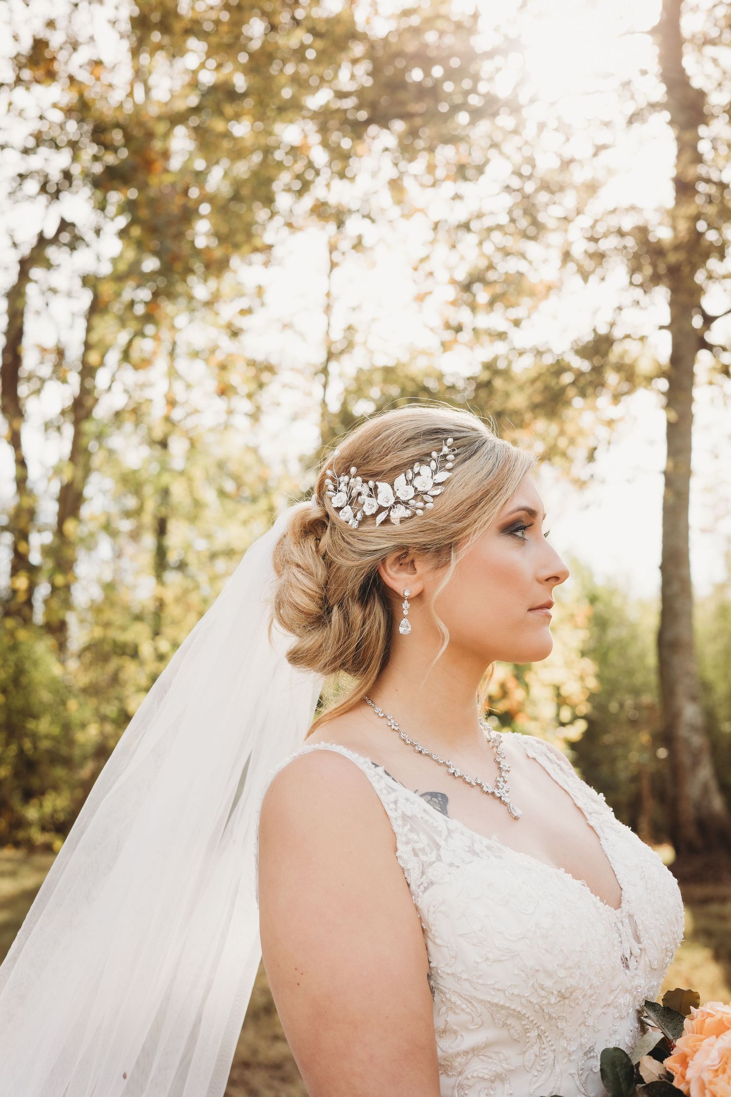 Side profile wedding portraits with sparkling hair accessories and flowing veil in autumn light.