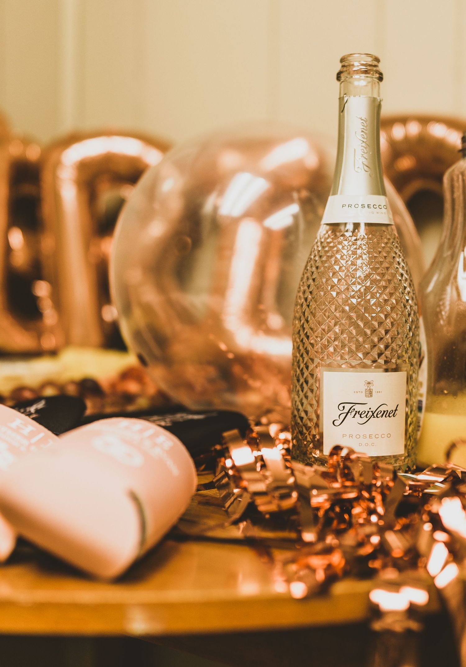 Vintage glass bottles and decorative elements arranged with soft lighting and rose gold accents.