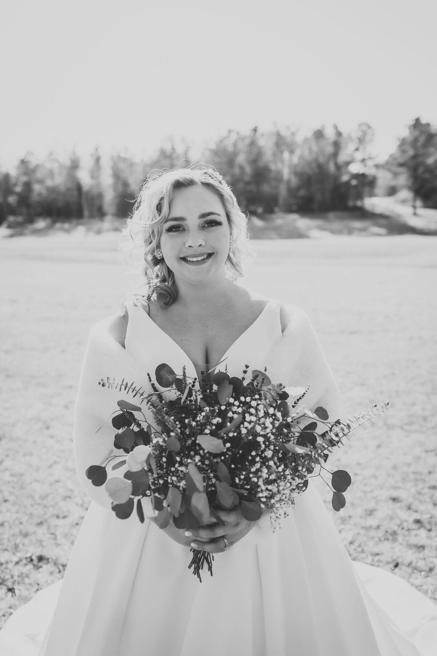 Black and white portrait of a bridal bouquet with eucalyptus and delicate flowers.