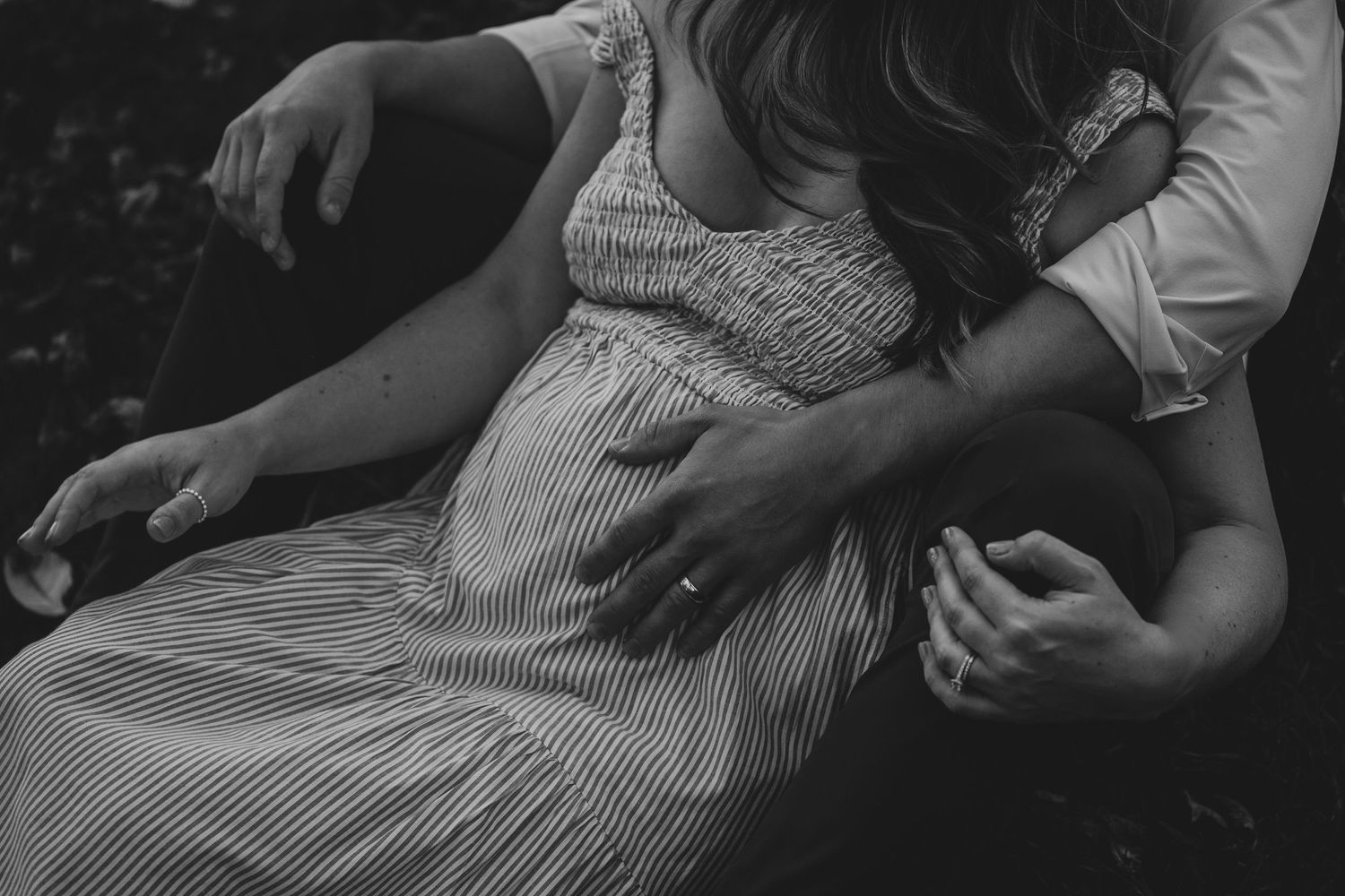 Intimate black and white photo of couple in relaxed casual setting showing tender moment together.