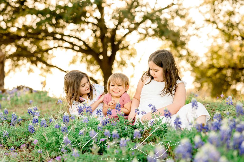 Joyful springtime moment among blooming bluebonnets during golden hour.