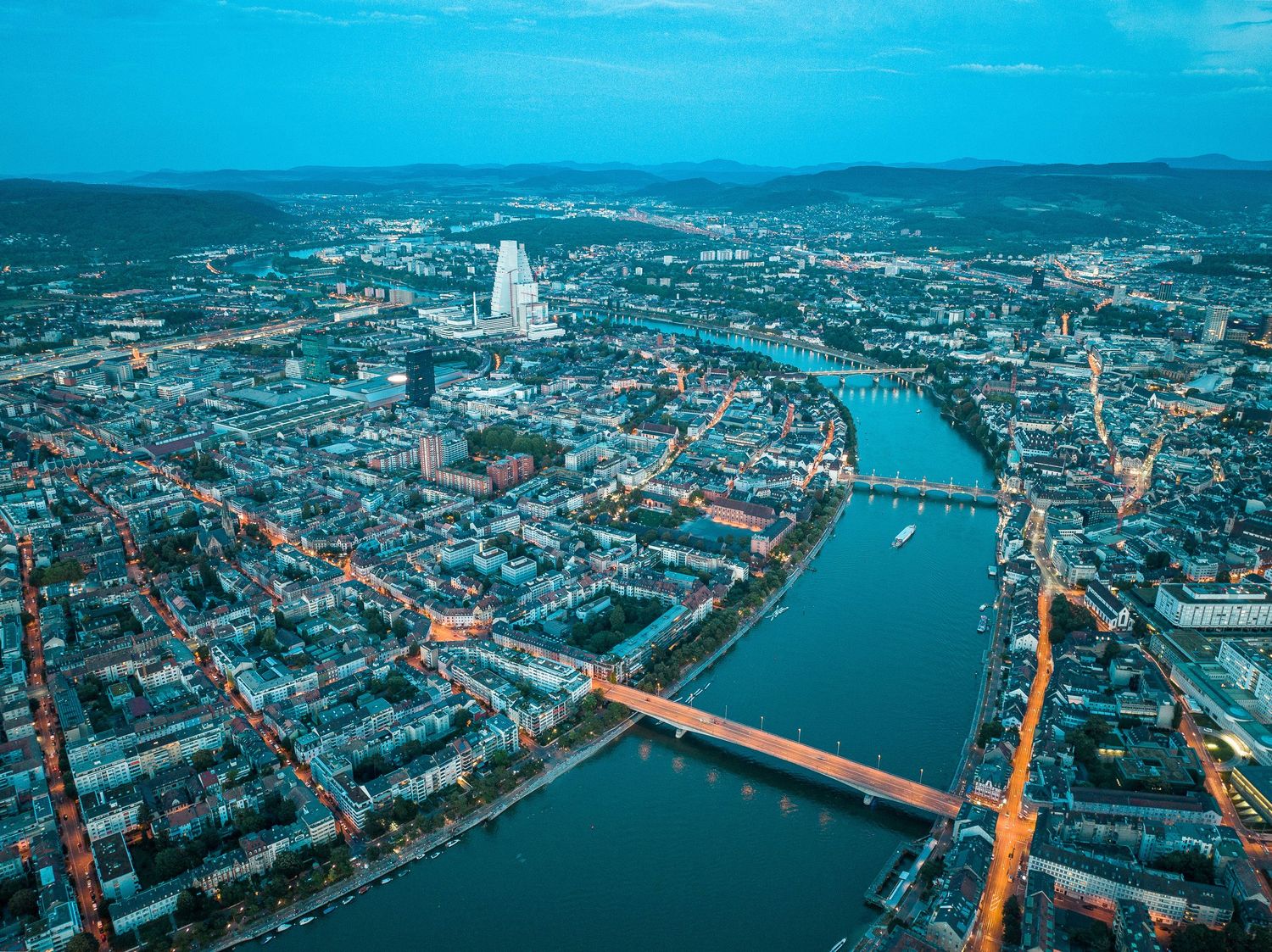 Aerial view of a European city with river, bridges and historic architecture.