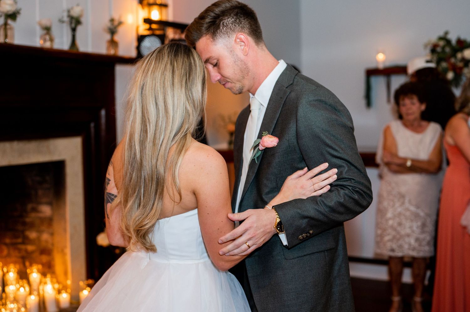Candlelit wedding reception featuring couple's romantic dance moment.