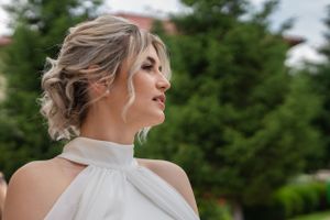 Close-up portrait shots showing elegant updo hairstyle against a green outdoor backdrop.