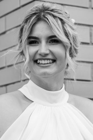 Black and white portraits showing joyful expressions in a white high-neck outfit.