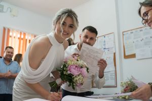 People gathered in an office setting reviewing documents together.