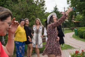 Wedding celebration in a garden setting with guests in colorful attire.