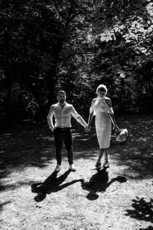 Black and white series showing shadows of people dancing on gravel path.