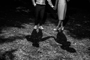 Series of shadows cast on gravel path showing movement and dance.
