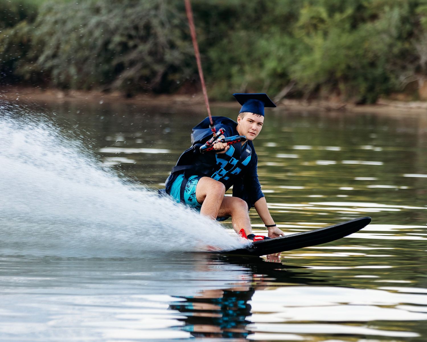 Series of water sports action shots showing senior gliding across lake surface. Middle TN senior photographer