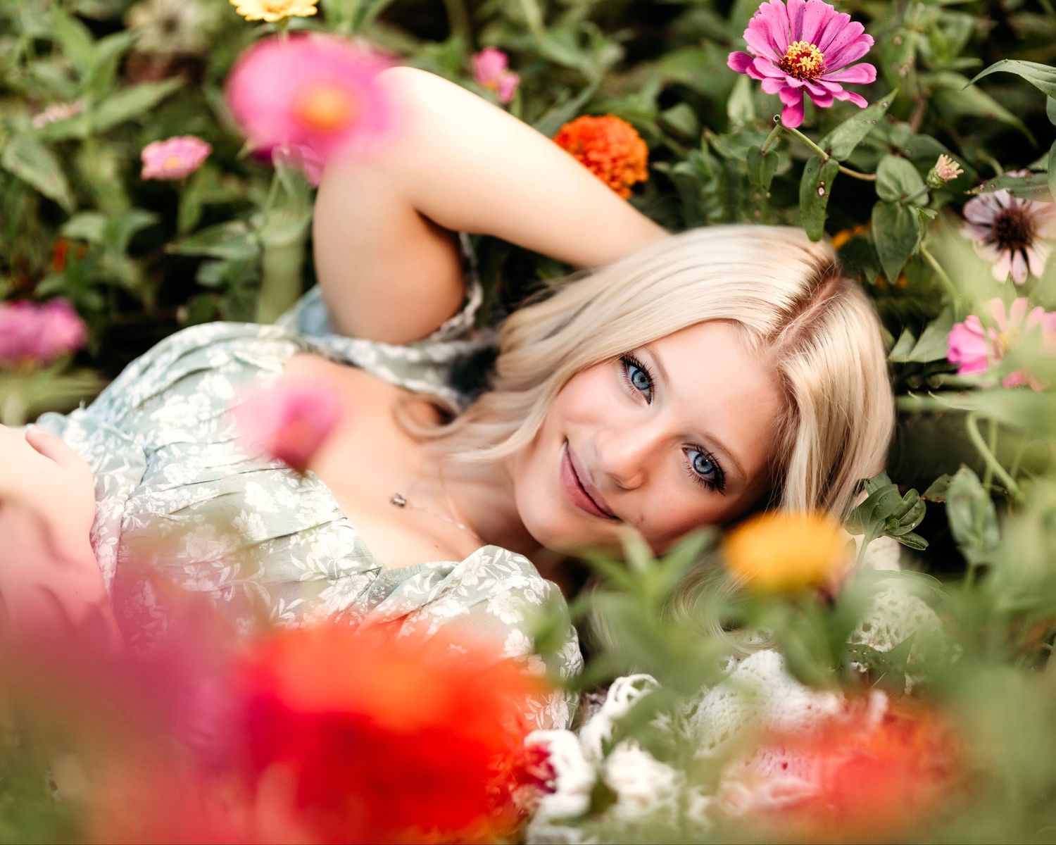 Ethereal garden portrait surrounded by blooming pink and orange flowers. Middle TN senior photographer