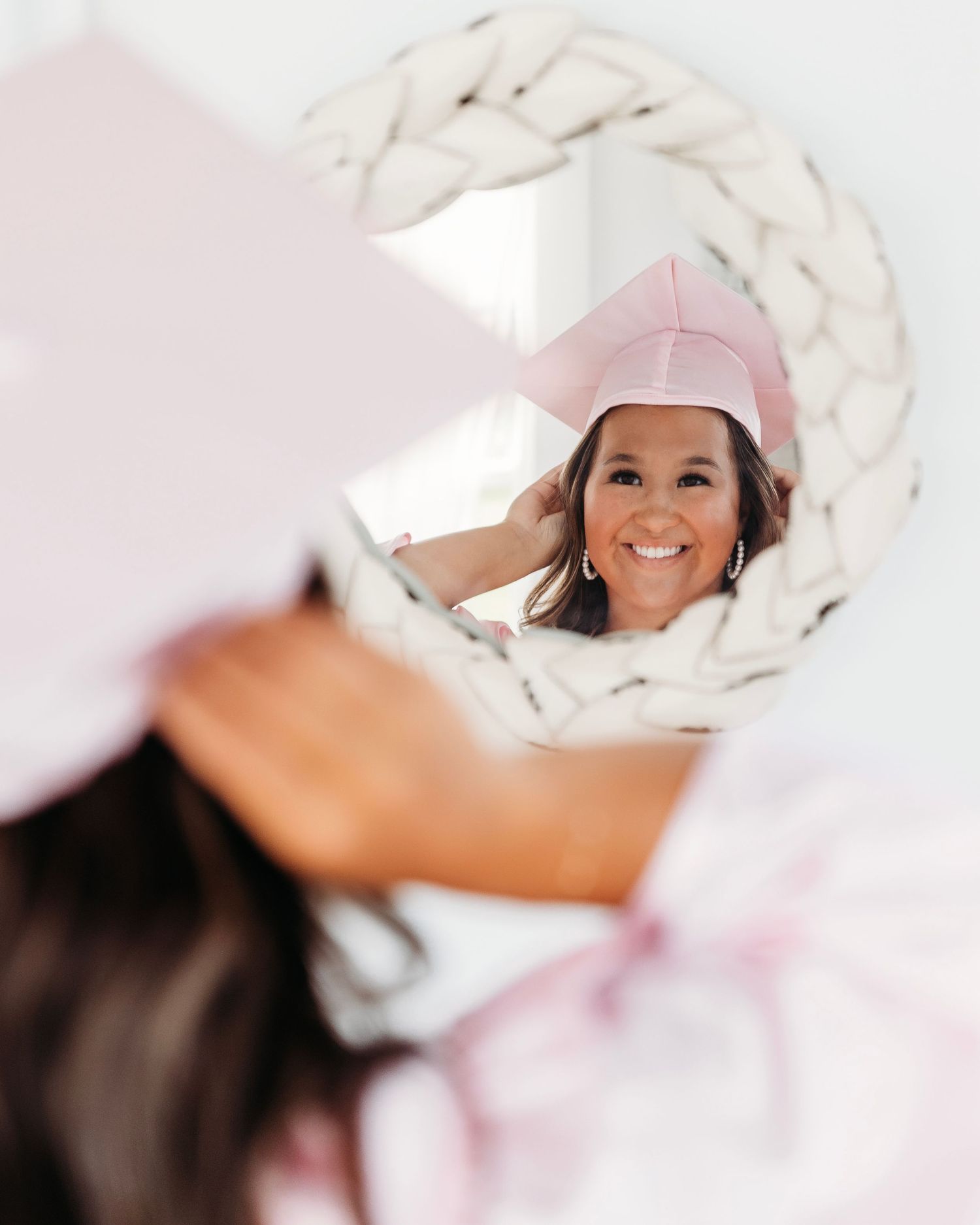 Bright and airy portrait session with soft white fabric and natural lighting cap and gown. Middle TN senior photographer