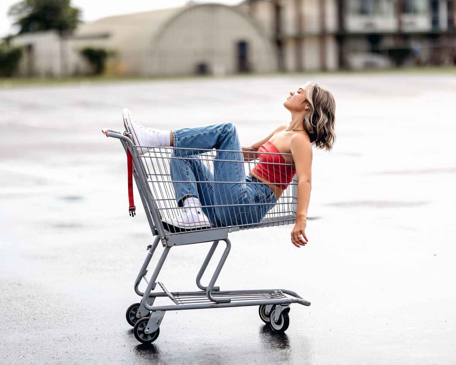 Creative photo series of person lying in shopping cart against white background.Middle TN senior photographer