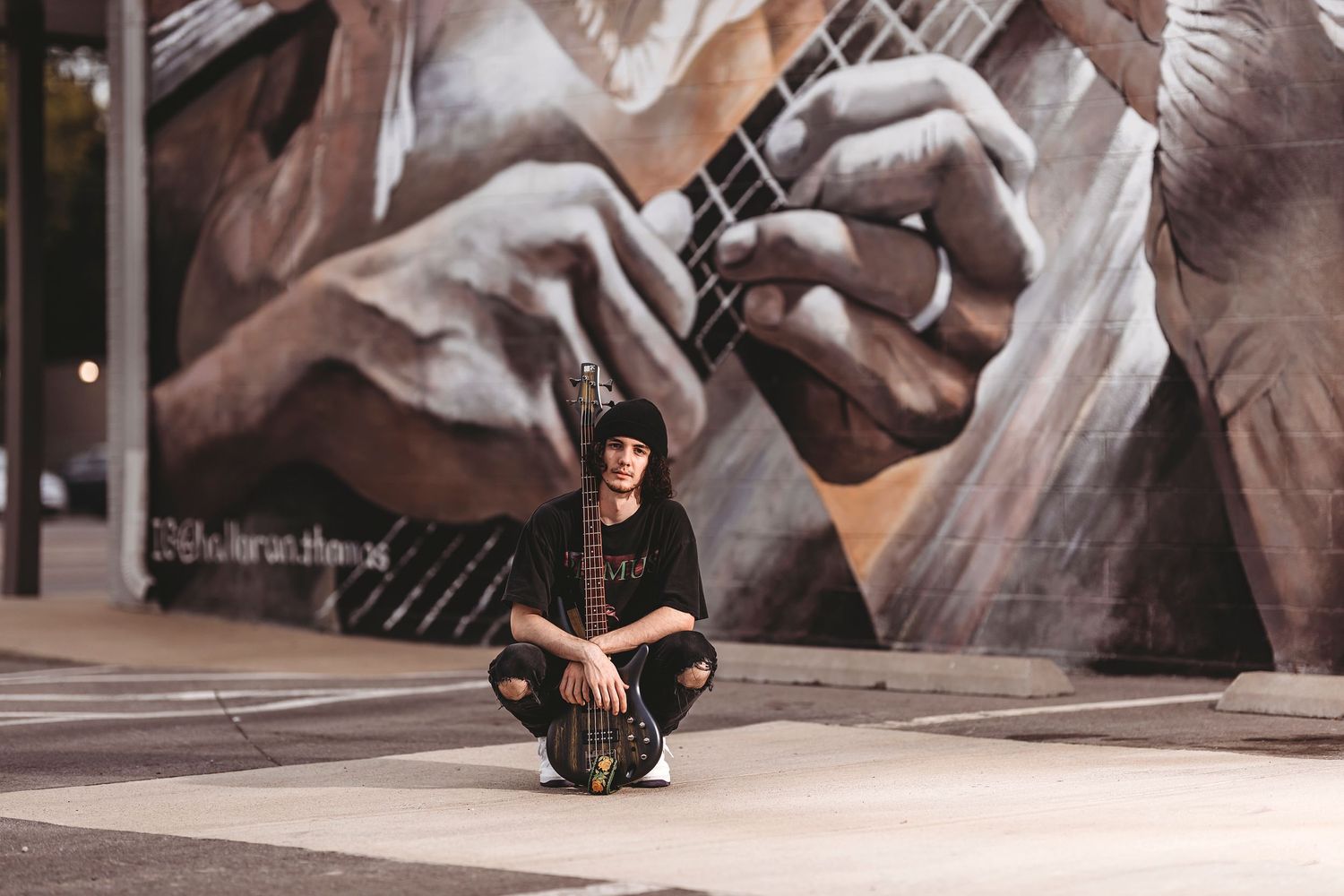 Dynamic urban photoshoot against large black and white graffiti wall. Middle TN senior photographer