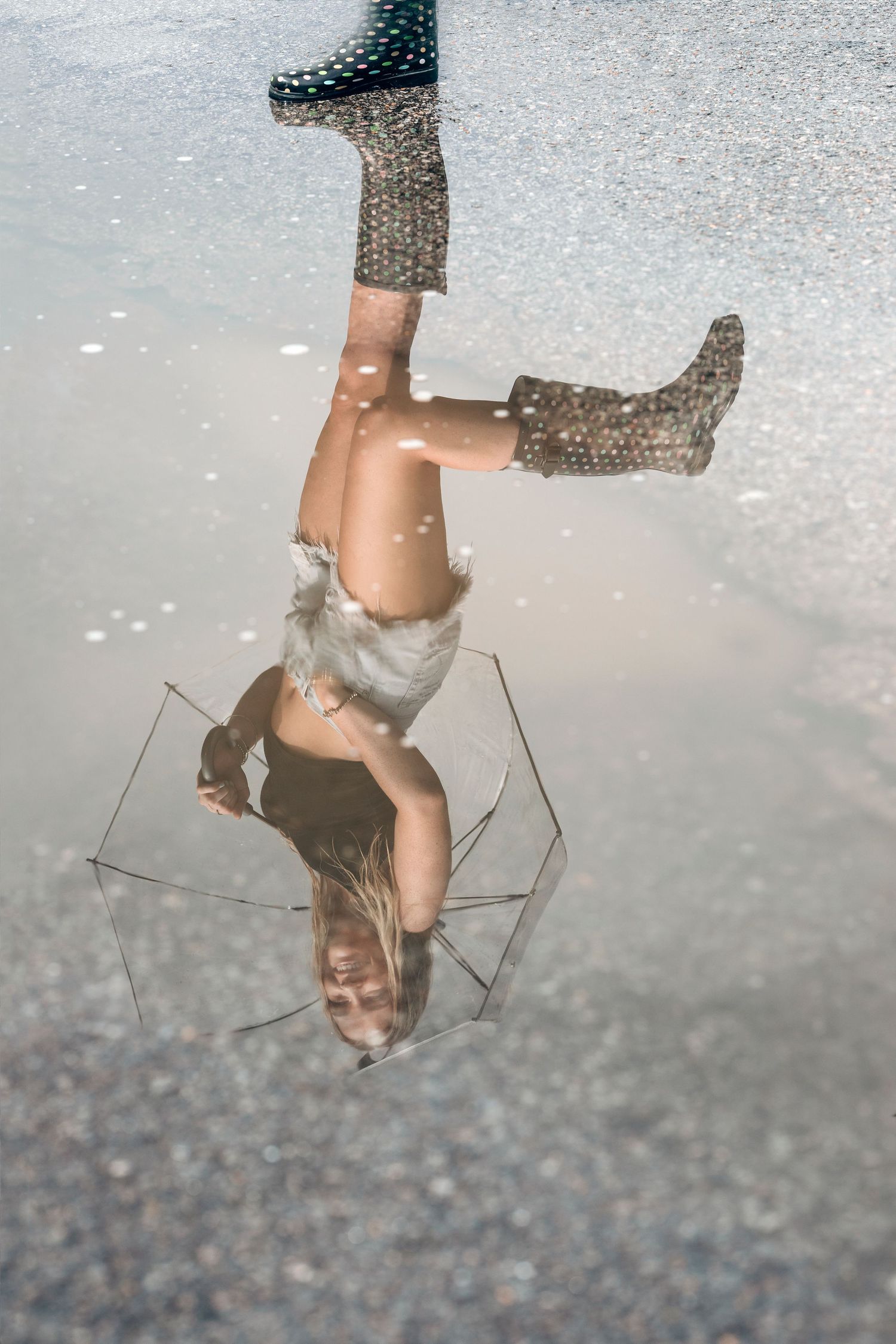 Artistic reflection series in puddle water creating mirror-like symmetry. Middle TN senior photographer