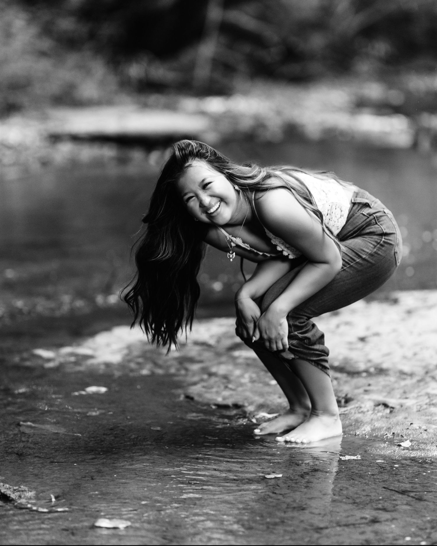 Black and white artistic portrait series near water with dynamic poses. Middle TN senior photographer