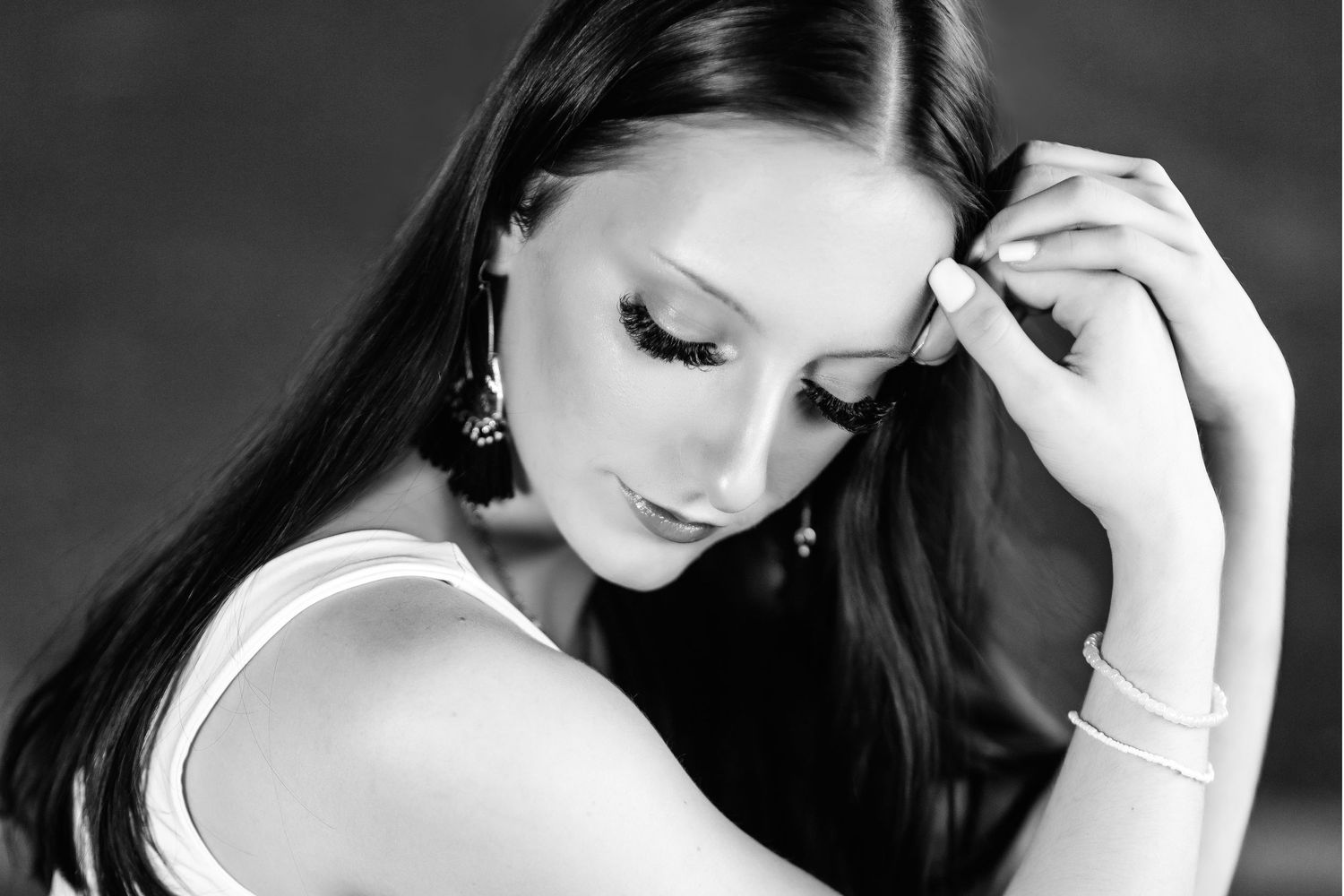 Elegant black and white portrait with dramatic lighting and classic pose. Middle TN senior photographer