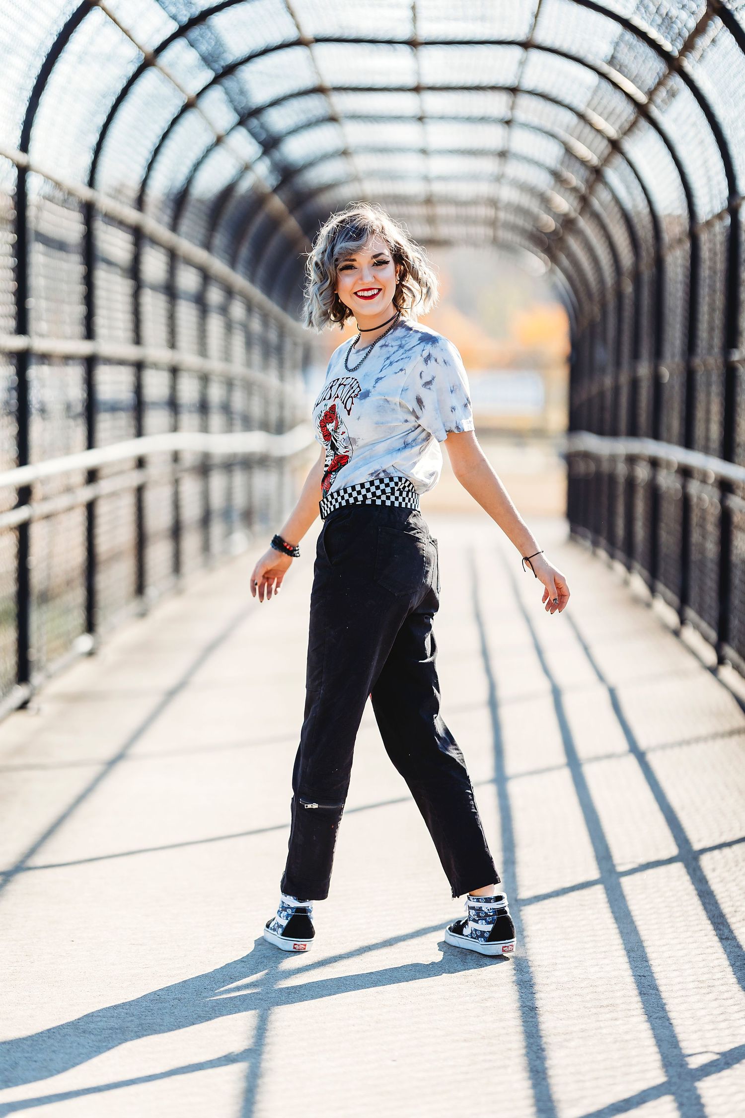 Playful sequence of movement captured in a bright walkway with geometric shadows and patterns. Middle TN senior photographer
