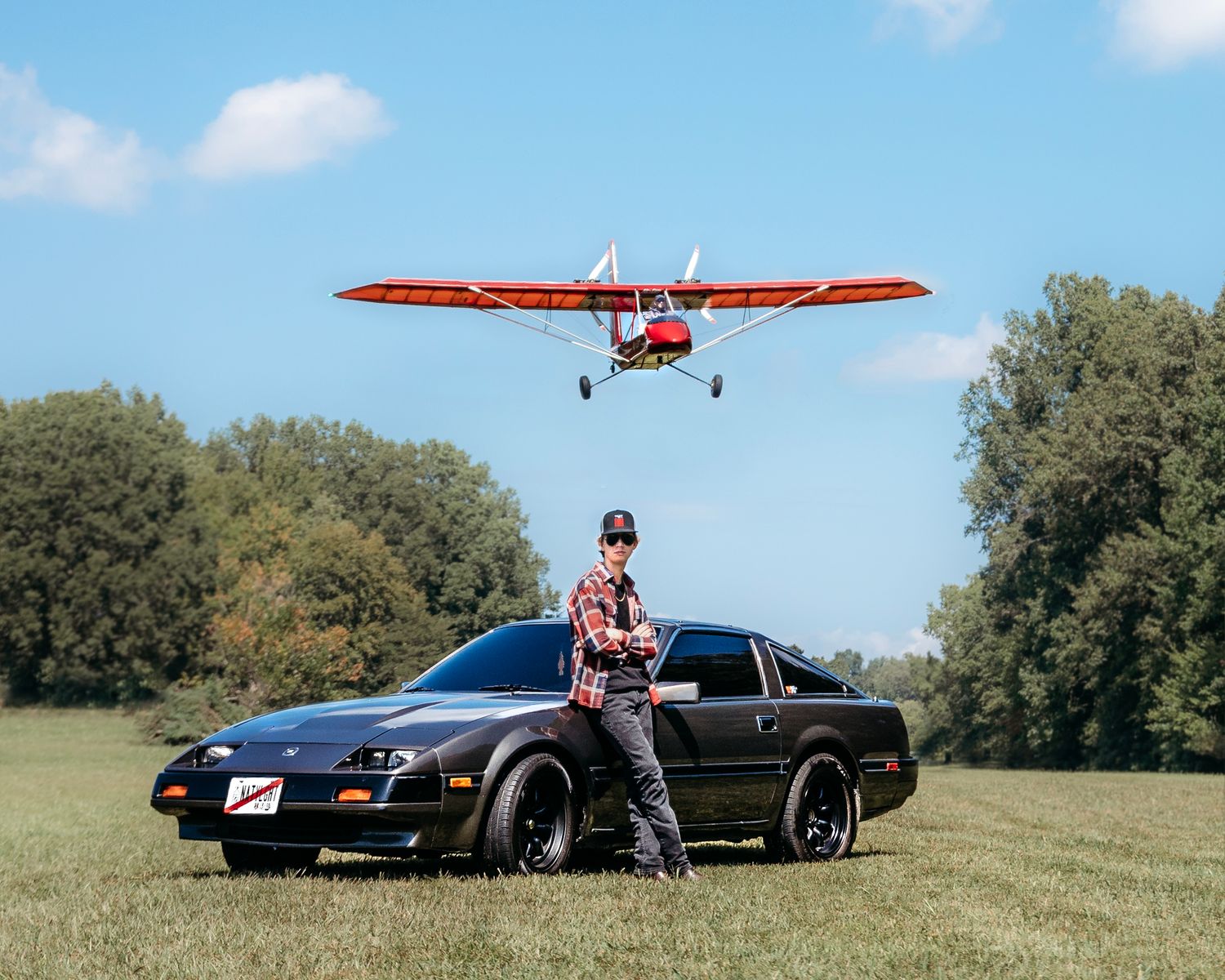 Collection of sports cars and small aircraft in sunny field with trees. Middle TN senior photographer