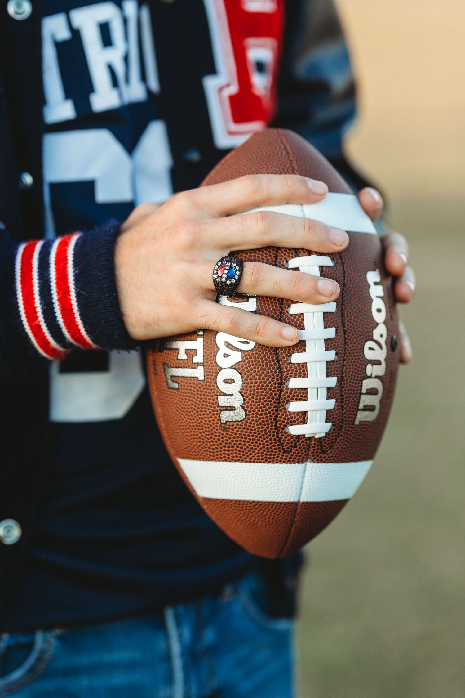 Close-up sequence of hands holding a football showing different angles and grips. Middle TN senior photographer