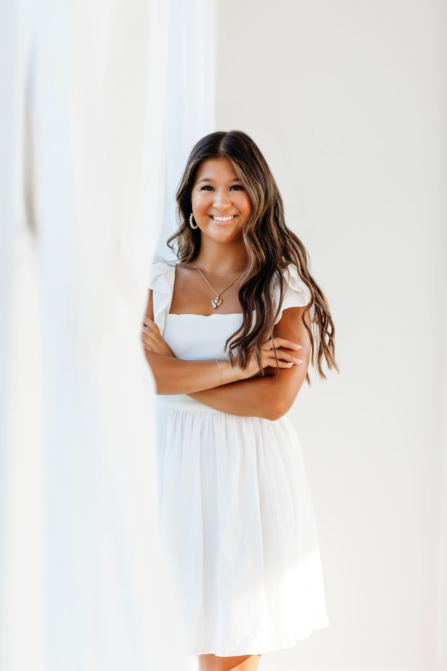 Bright studio portraits in white dress against clean background. Middle TN senior photographer