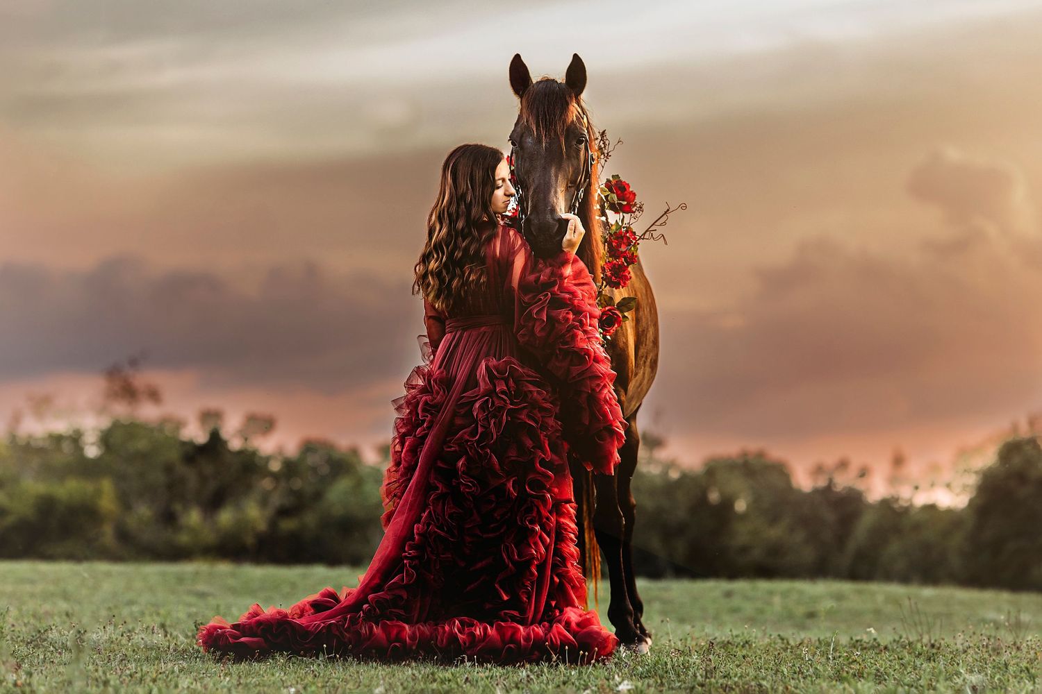 Horse and rider silhouetted against a golden sunset in a grassy field. Middle TN senior photographer