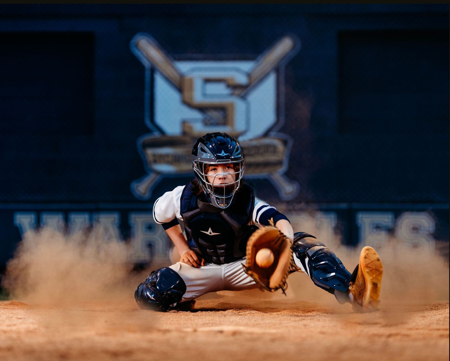 Baseball player sliding into base creating dramatic dust cloud during game. Middle TN senior photographer